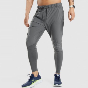 Pantalons esportius de polièster d'assecat ràpid amb butxaca a la cintura Pantalons jogger ajustats personalitzats per a homes