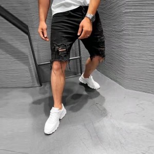 Pantalones cortos negros rasgados con parte inferior deshilachada populares para hombres