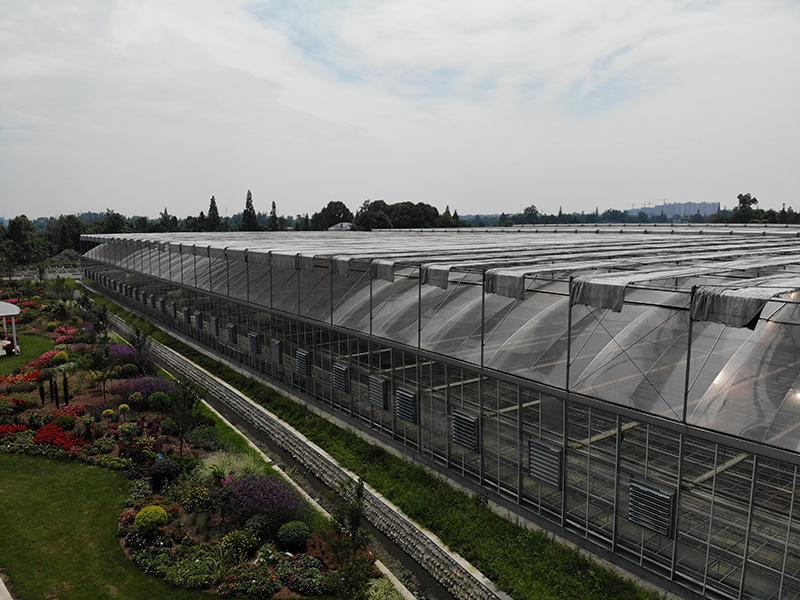 Low Cost Large Commercial PO Film And Glass  Cover Gothic Type Agriculture Multi-span Greenhouse With Rolling Table-PMG002