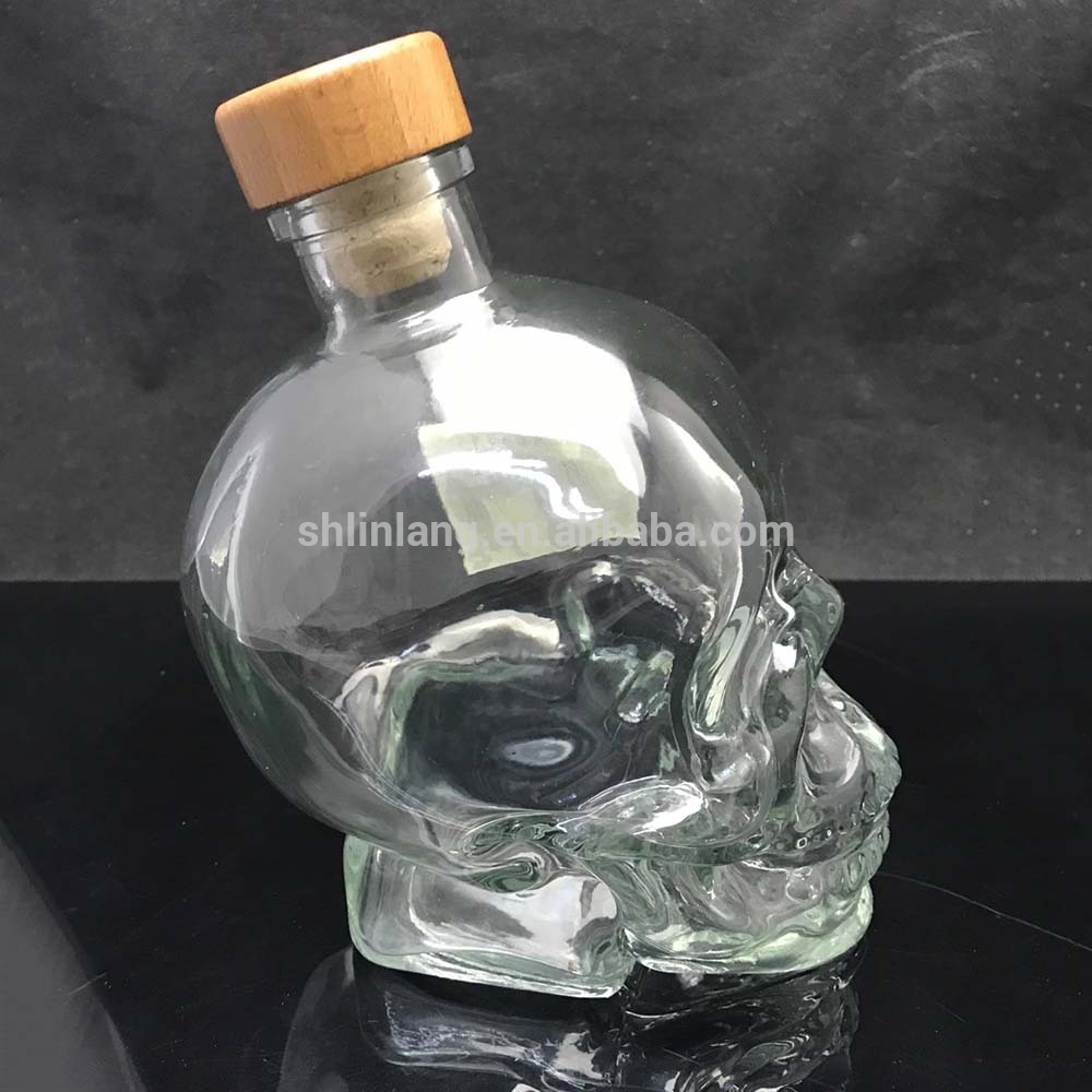 Shanghai Linlang high quality clear skull head shape glass liquor bottles with wooden or glass stopper