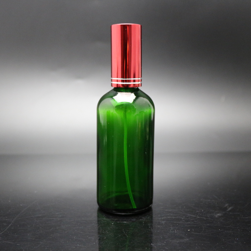 Wholesale Green spray 100ml round glass essential oil bottle with Aluminum mist sprayer