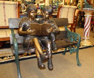 bronze girl sitting reading statue with the bronze  life size dog statue