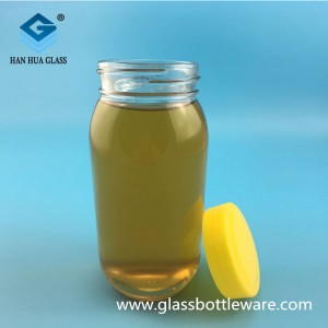 Wholesale price of 700ml round glass honey bottle