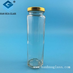 Botella de miel hexagonal de vidrio transparente de 180 ml.