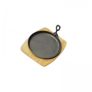 Round cast iron baking pan with board and fork