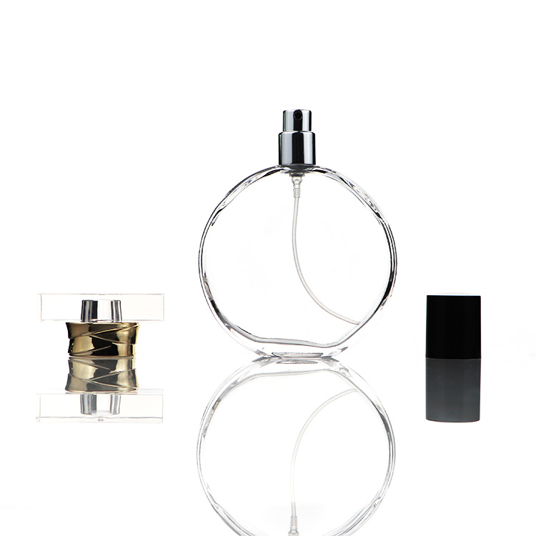 ポンプ噴霧器が付いている空の平らな円形のガラス香水瓶