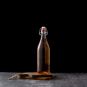 Bottiglia di vetru trasparente di alta qualità da 1000 ml cù tappo flip