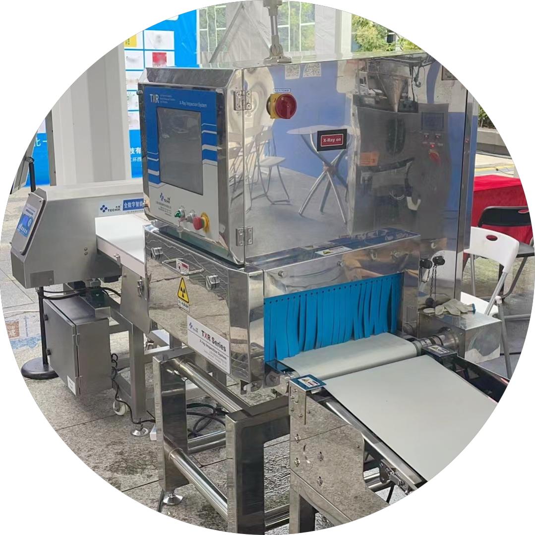 Woon Liangzhilong-voedselmateriaal-uitstalling by, Techik-metaalopsporingsmasjiene help kitskosvoedselindustrie-kontaminante-inspeksie