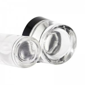Clear oval glass bottle and jar skin care set with black pumps and lids