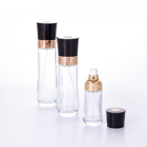 Wholesale luxury transparent glass bottle and jar with beautifully carved black cap for skincare packaging set