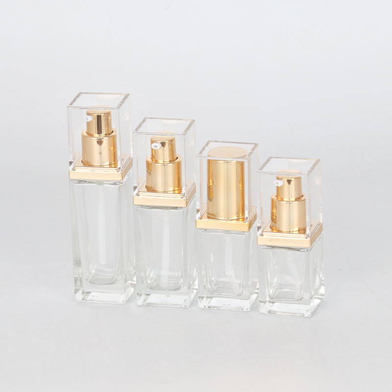 Cosmetic Packaging Glass Bottles - Clear square glass bottles with golden lotion pump and cover – Uzone