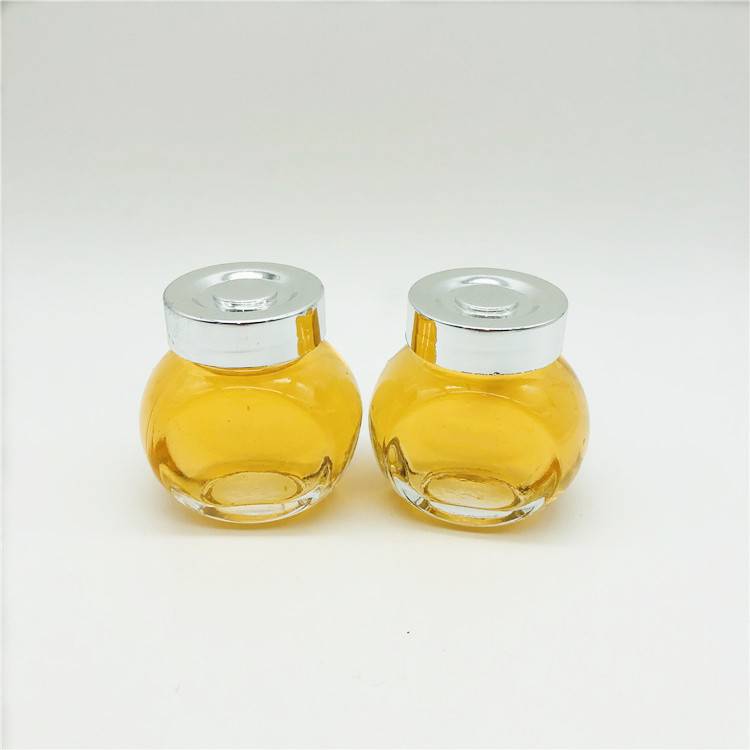 Wholesale small 50ml flat drum glass bottle/jar with plastic cap