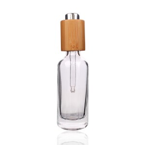 bouteille en verre de compte-gouttes d'huile essentielle cosmétique ronde unique avec bouchon en bambou