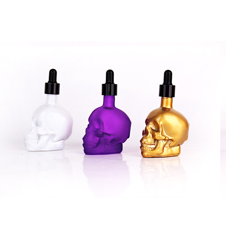 Wholesale Custom colorful 50ml skull head essential oil glass bottle