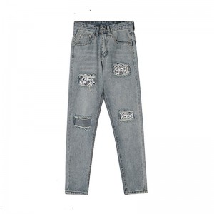 Fashionable washed men’s jeans with holes and patches